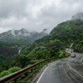 Shirdi monsoon yatra route — misty green Sahyadri ghat highway in the rains