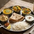 Veg food in Shirdi shown as a vegetarian thali with chapati, rice, dal, sabji and sweet